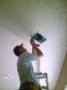 A Smarthome Engineer Installing In-Ceiling Speakers for A Client's Home Theater and Whole House Audio System's 